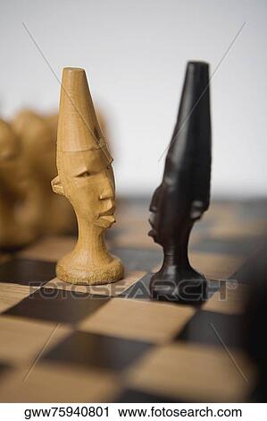 Close-up of two chess pieces on a chessboard View Large Photo Image Stock Image - Close-up of two chess pieces on a chessboard. Fotosearch