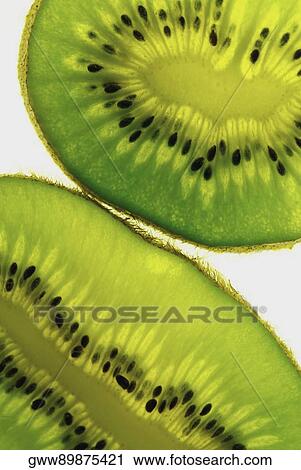 Close-up of two slices of kiwi fruit View Large Photo Image Stock Image - Close-up of two slices of kiwi fruit. Fotosearch