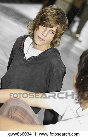 Close-up of two teenage boys sitting together View Large Photo Image Stock Image - Close-up of two teenage boys sitting together. Fotosearch