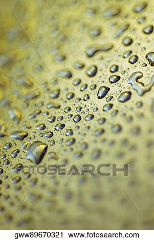 Stock Image - Close-up of water droplets on a surface. Fotosearch
