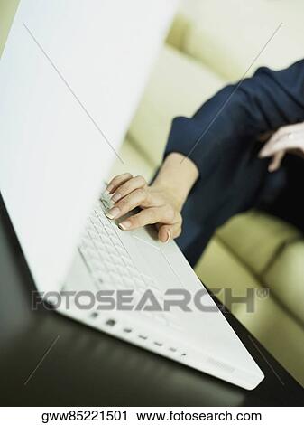 Close-up of woman's hand using a laptop View Large Photo Image Stock Image - Close-up of woman's hand using a laptop. Fotosearch