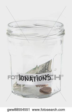 Dollar bills and coins in a jar View Large Photo Image Stock Image - Dollar bills and coins in a jar. Fotosearch