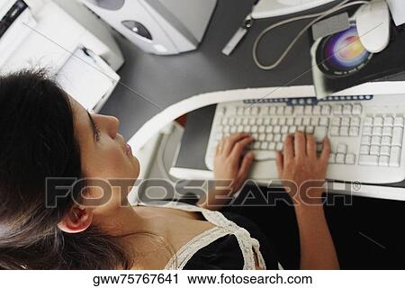 Stock Image - High angle view of a businesswoman using a computer. Fotosearch