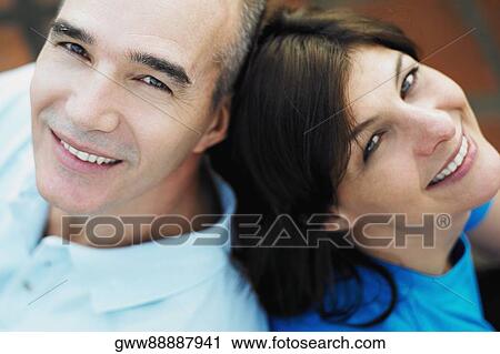High angle view of a mature couple sitting back to back View Large Photo Image Stock Image - High angle view of a mature couple sitting back to back. Fotosearch