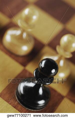 High angle view of three chess pieces on a chessboard View Large Photo Image Stock Image - High angle view of three chess pieces on a chessboard. Fotosearch
