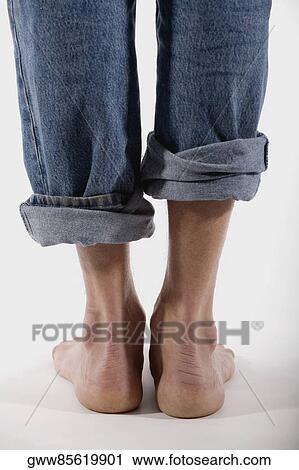 Low section view of a man barefooted View Large Photo Image Stock Image - Low section view of a man barefooted. Fotosearch