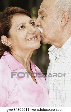 Mature man kissing a mature woman View Large Photo Image Stock Image - Mature man kissing a mature woman. Fotosearch