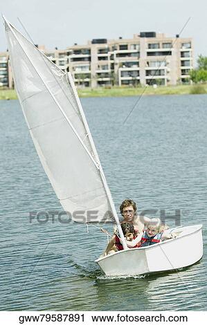 Mid adult man with his children in a sailboat View Large Photo Image Stock Image - Mid adult man with his children in a sailboat. Fotosearch