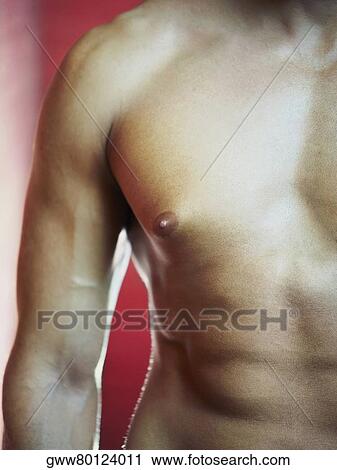 Stock Image - Mid section view of a bare chested man. Fotosearch