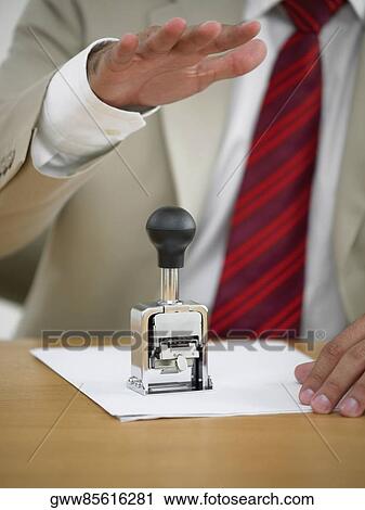 Mid section view of a businessman using a stamp View Large Photo Image Stock Image - Mid section view of a businessman using a stamp. Fotosearch
