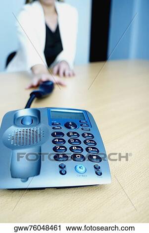 Mid section view of a woman reaching towards a telephone receiver View Large Photo Image Stock Image - Mid section view of a woman reaching towards a telephone receiver. Fotosearch
