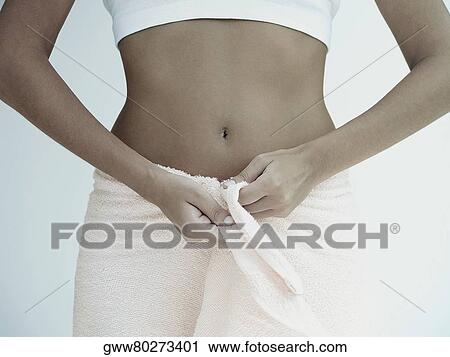Mid section view of a woman with a towel around her waist View Large Photo Image Stock Image - Mid section view of a woman with a towel around her waist. Fotosearch