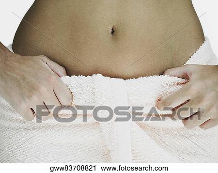 Mid section view of a woman with a towel around her waist View Large Photo Image Stock Image - Mid section view of a woman with a towel around her waist. Fotosearch