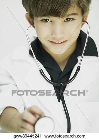 Stock Image - Portrait of a boy dressed as a doctor. Fotosearch