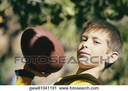 Portrait of a boy holding a rugby ball View Large Photo Image Stock Image - Portrait of a boy holding a rugby ball. Fotosearch