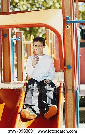 Portrait of a boy holding an ice-cream cone View Large Photo Image Stock Image - Portrait of a boy holding an ice-cream cone. Fotosearch