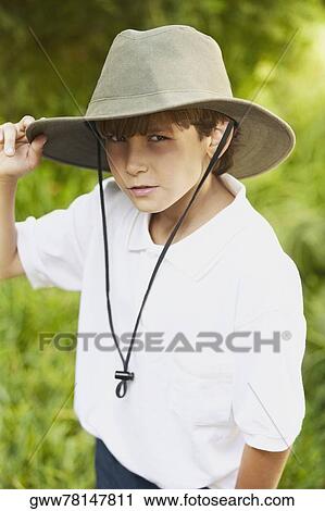 Portrait of a boy holding his hat View Large Photo Image Stock Image - Portrait of a boy holding his hat. Fotosearch