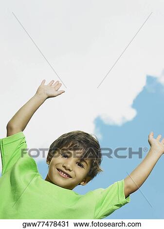 Portrait of a boy smiling with his arms raised View Large Photo Image Stock Image - Portrait of a boy smiling with his arms raised. Fotosearch