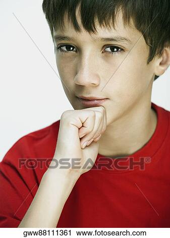 Portrait of a boy with his hand on his chin View Large Photo Image Stock Image - Portrait of a boy with his hand on his chin. Fotosearch