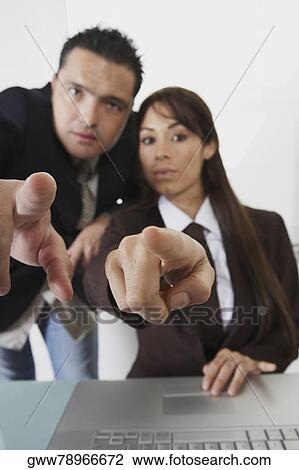Portrait of a businessman and a businesswoman pointing forward View Large Photo Image Stock Image - Portrait of a businessman and a businesswoman pointing forward. Fotosearch