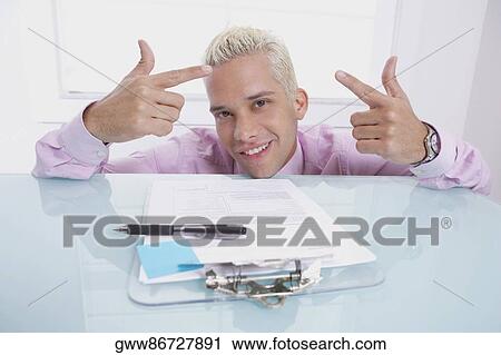 Portrait of a businessman gesturing and smiling View Large Photo Image Stock Image - Portrait of a businessman gesturing and smiling. Fotosearch