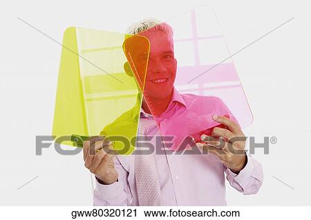 Portrait of a businessman holding two clipboards View Large Photo Image Stock Image - Portrait of a businessman holding two clipboards. Fotosearch