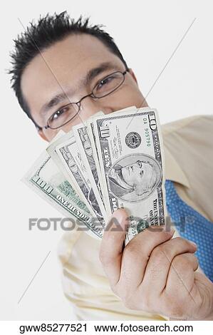 Portrait of a businessman showing American dollar bills View Large Photo Image Stock Image - Portrait of a businessman showing American dollar bills. Fotosearch