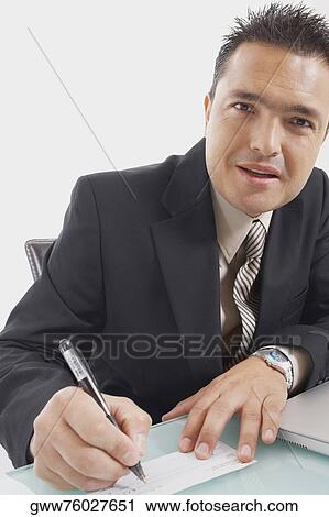 Portrait of a businessman writing a check View Large Photo Image Stock Image - Portrait of a businessman writing a check. Fotosearch