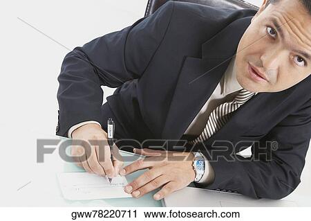 Stock Image - Portrait of a businessman writing a check. Fotosearch