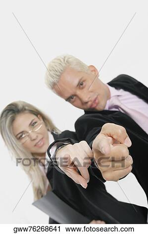 Portrait of a businesswoman and a businessman standing back to back and pointing View Large Photo Image Stock Image - Portrait of a businesswoman and a businessman standing back to back and pointing. Fotosearch
