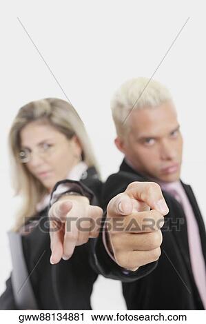 Portrait of a businesswoman and a businessman standing back to back and pointing View Large Photo Image Stock Image - Portrait of a businesswoman and a businessman standing back to back and pointing. Fotosearch