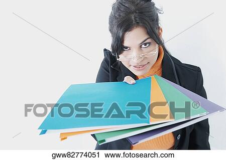 Portrait of a businesswoman holding files View Large Photo Image Stock Image - Portrait of a businesswoman holding files. Fotosearch