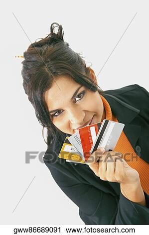 Portrait of a businesswoman holding credit cards and smiling View Large Photo Image Stock Image - Portrait of a businesswoman holding credit cards and smiling. Fotosearch