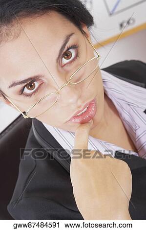 Stock Image - Portrait of a businesswoman thinking. Fotosearch