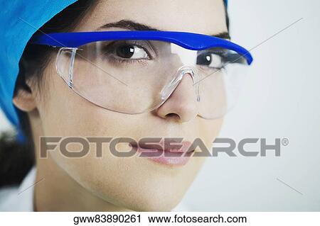 Portrait of a female doctor wearing a surgical cap and protective eyewear View Large Photo Image Stock Image - Portrait of a female doctor wearing a surgical cap and protective eyewear. Fotosearch