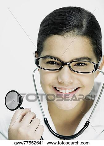 Portrait of a girl holding a stethoscope and smiling View Large Photo Image Stock Image - Portrait of a girl holding a stethoscope and smiling. Fotosearch