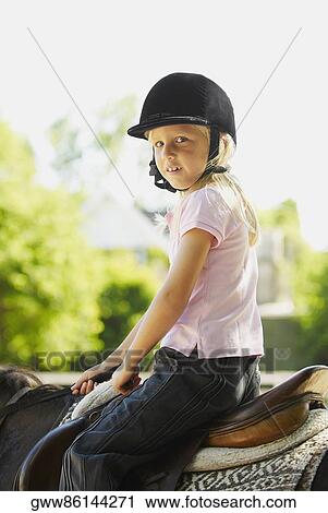 Portrait of a girl horseback riding View Large Photo Image Stock Image - Portrait of a girl horseback riding. Fotosearch