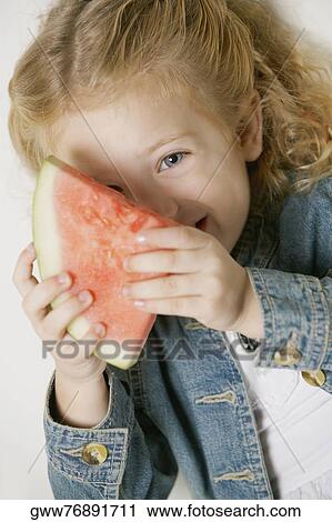 Portrait of a girl smiling and holding a slice of watermelon View Large Photo Image Stock Image - Portrait of a girl smiling and holding a slice of watermelon. Fotosearch