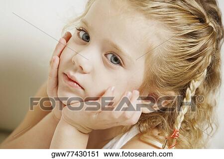 Stock Image - Portrait of a girl thinking. Fotosearch