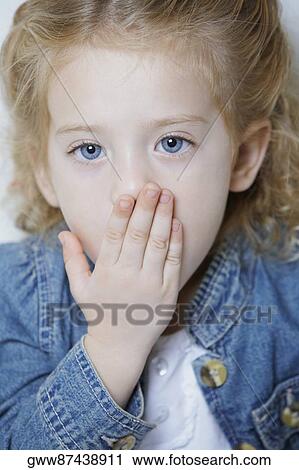 Portrait of a girl with her hands on her mouth View Large Photo Image Stock Image - Portrait of a girl with her hands on her mouth. Fotosearch