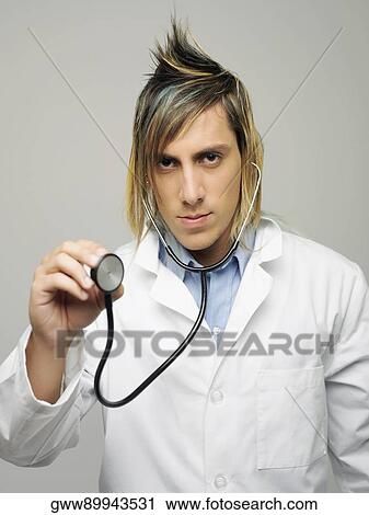Portrait of a male doctor holding a stethoscope View Large Photo Image Stock Image - Portrait of a male doctor holding a stethoscope. Fotosearch