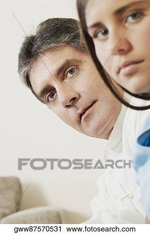 Portrait of a mature man with his daughter looking serious View Large Photo Image Stock Image - Portrait of a mature man with his daughter looking serious. Fotosearch