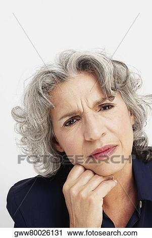 Portrait of a mature woman looking pensive View Large Photo Image Stock Image - Portrait of a mature woman looking pensive. Fotosearch