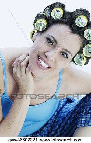 Portrait of a mature woman wearing hair curlers and smiling View Large Photo Image Stock Image - Portrait of a mature woman wearing hair curlers and smiling. Fotosearch