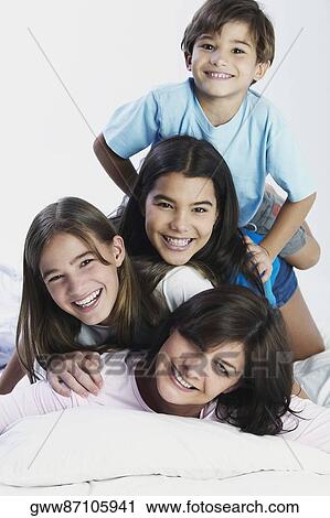 Portrait of a mature woman with her two daughters and son View Large Photo Image Stock Image - Portrait of a mature woman with her two daughters and son. Fotosearch