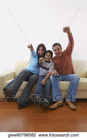 Portrait of a mid adult man and a young woman with their son sitting on a couch View Large Photo Image Stock Image - Portrait of a mid adult man and a young woman with their son sitting on a couch. Fotosearch