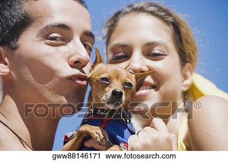 Portrait of a mid adult man and a young woman with a puppy View Large Photo Image Stock Image - Portrait of a mid adult man and a young woman with a puppy. Fotosearch