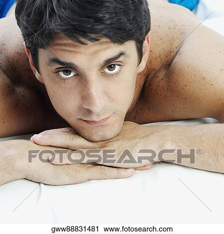 Portrait of a mid adult man lying on the bed View Large Photo Image Stock Image - Portrait of a mid adult man lying on the bed. Fotosearch
