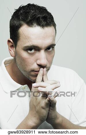 Portrait of a mid adult man with his fingers on his lips View Large Photo Image Stock Image - Portrait of a mid adult man with his fingers on his lips. Fotosearch