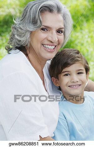 Portrait of a senior woman and her grandson smiling View Large Photo Image Stock Image - Portrait of a senior woman and her grandson smiling. Fotosearch